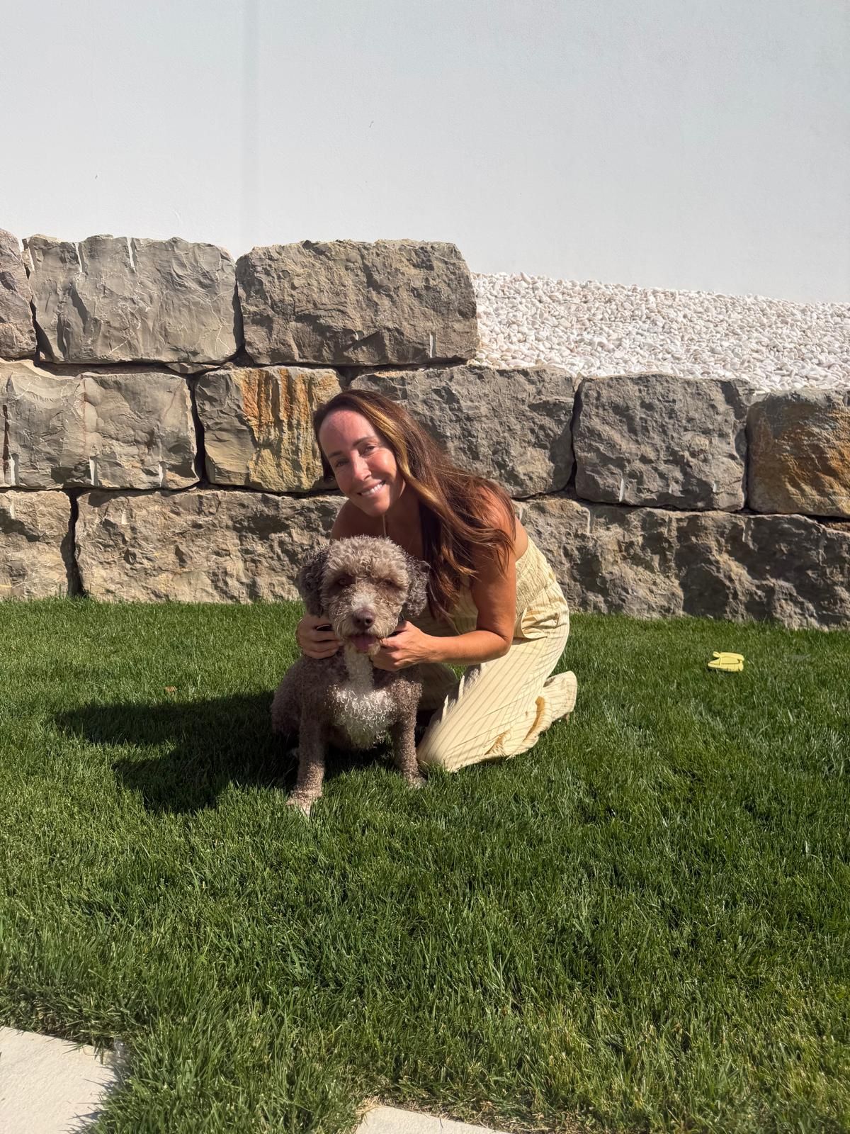 Lyndsey sitting on the grass with a dog